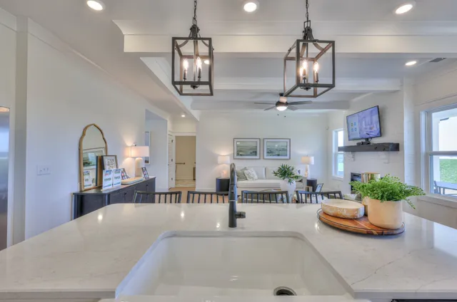 a kitchen with a dining table chairs wooden floor and appliances
