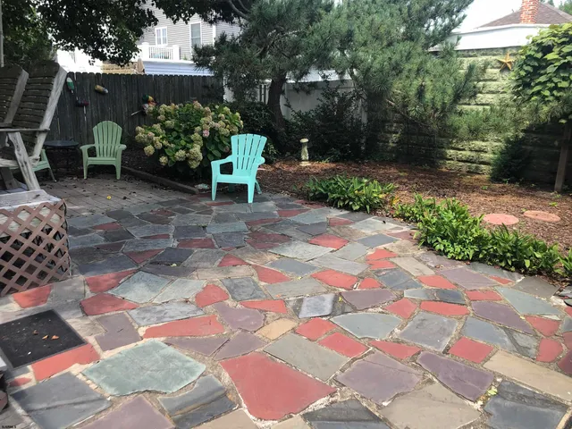 a view of a backyard with sitting area