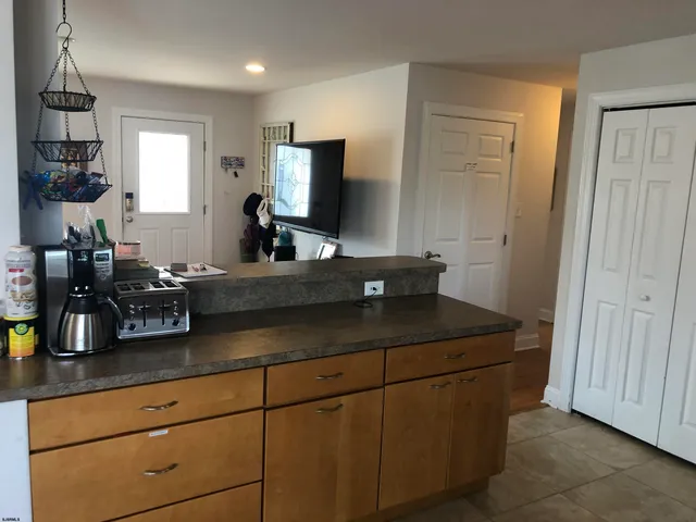 a kitchen with a sink and a mirror
