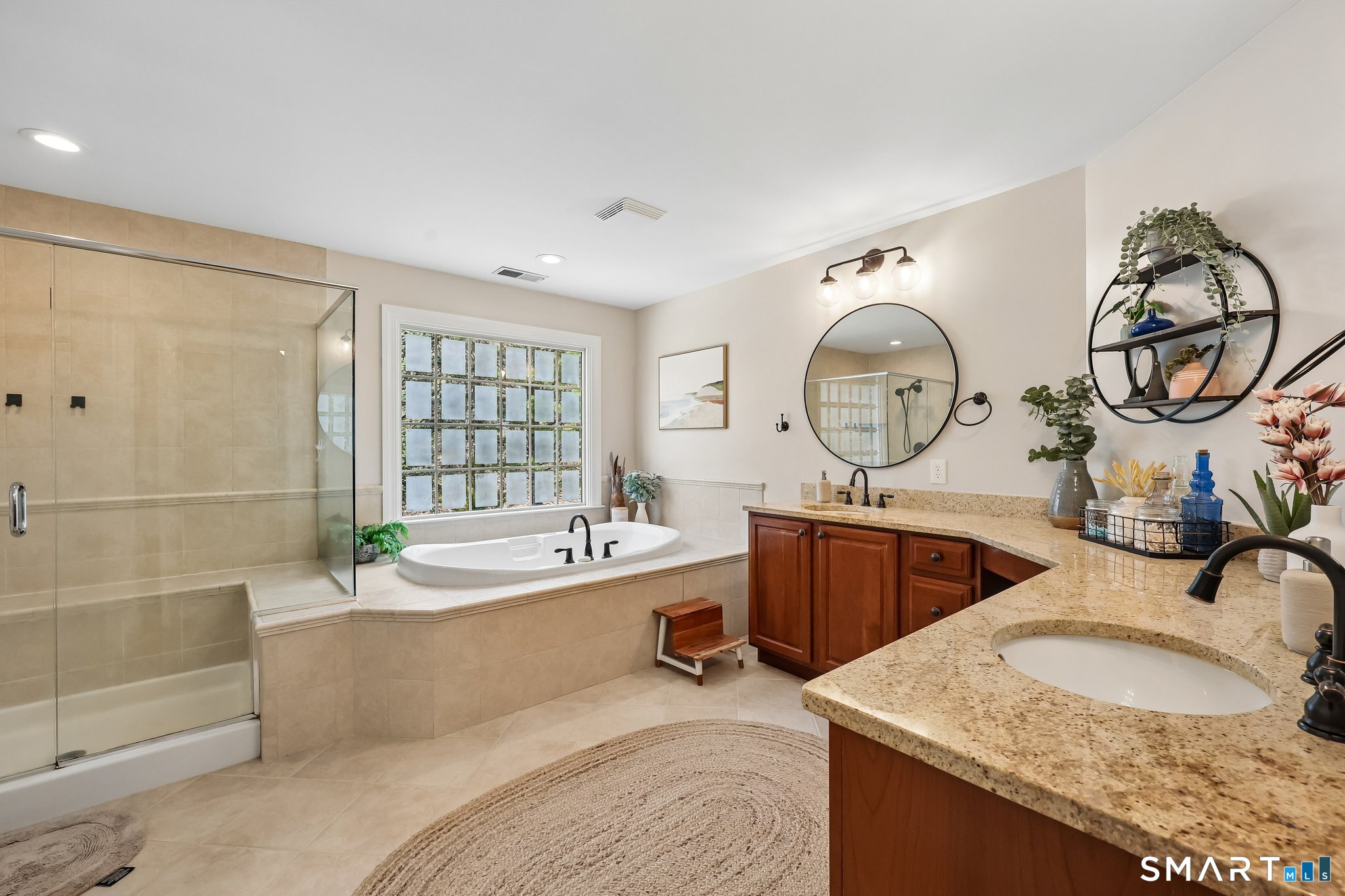 3 East Lake Road Danbury, CT 06811 - Photo 22 of 37 The spacious primary bath features a separate soaking tub, walk-in shower, and double sinks, offering both comfort and functionality in an elegantly designed setting.