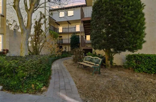 a view of a brick building with a bench in front of building