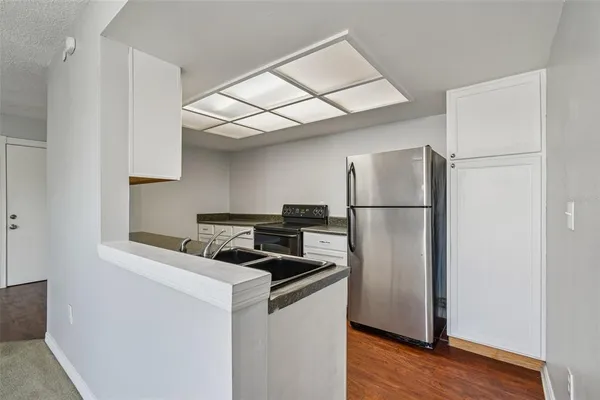 a kitchen with stainless steel appliances granite countertop a stove a refrigerator and a microwave