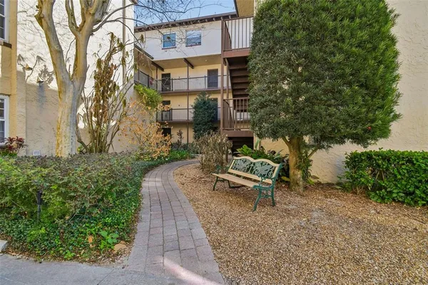 a view of a patio with table and chairs and potted plants