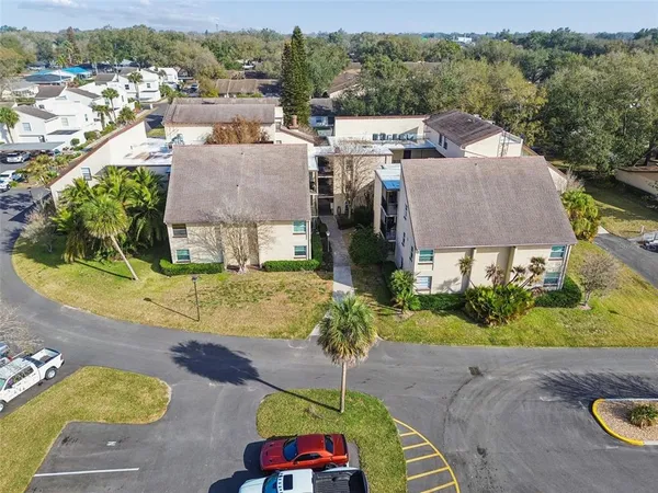 an aerial view of a house with a yard basket ball court and outdoor seating