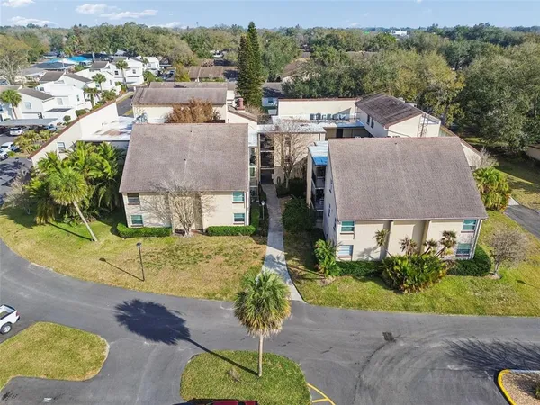an aerial view of a house with a yard and plants
