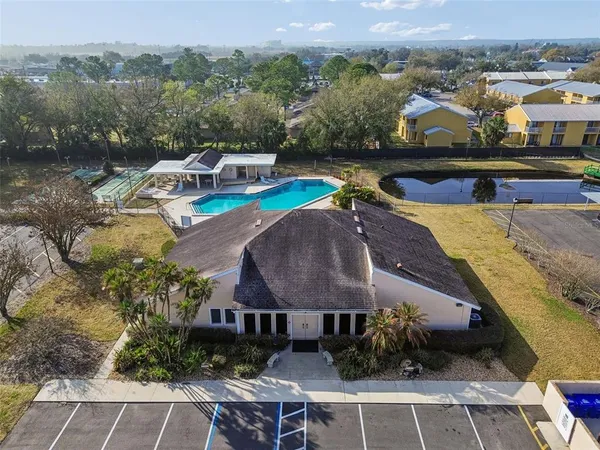 an aerial view of a house with a garden and lake view