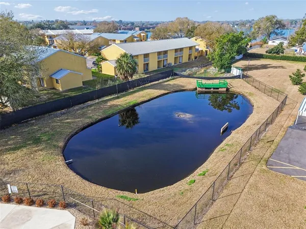 a view of a swimming pool with a patio and a garden