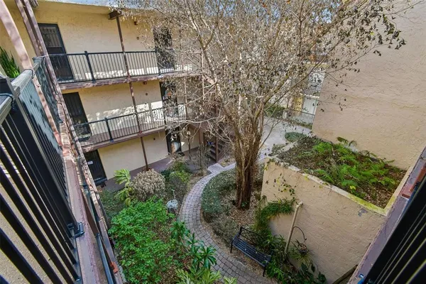 a view of a room with wooden floor and windows
