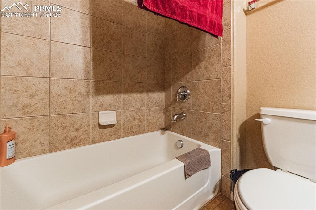 5354 Palomino Ranch Point, Unit 205 Colorado Springs, CO 80922 - Photo 19 of 26 a bathroom with a toilet and bathtub