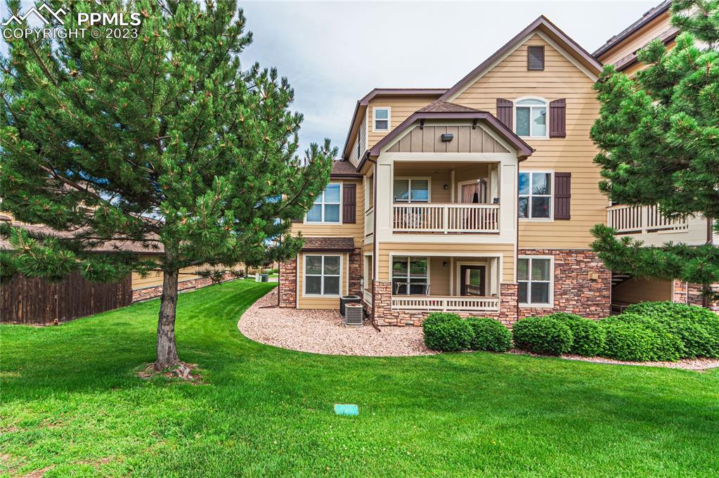 5354 Palomino Ranch Point, Unit 205 Colorado Springs, CO 80922 - Photo 2 of 26 a front view of a house with a yard