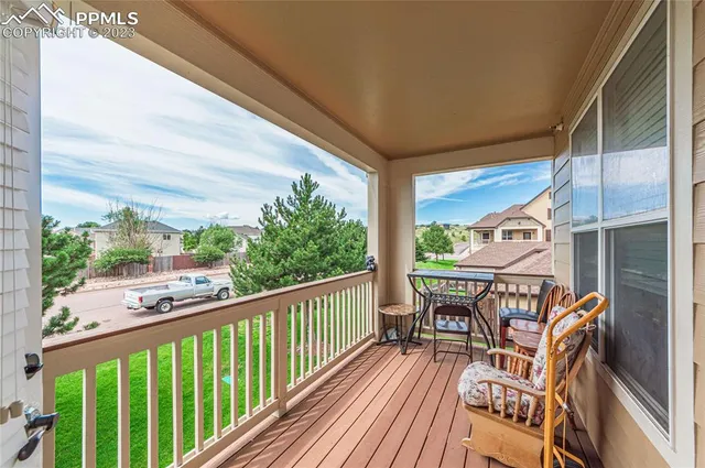 a view of a two chairs in the balcony