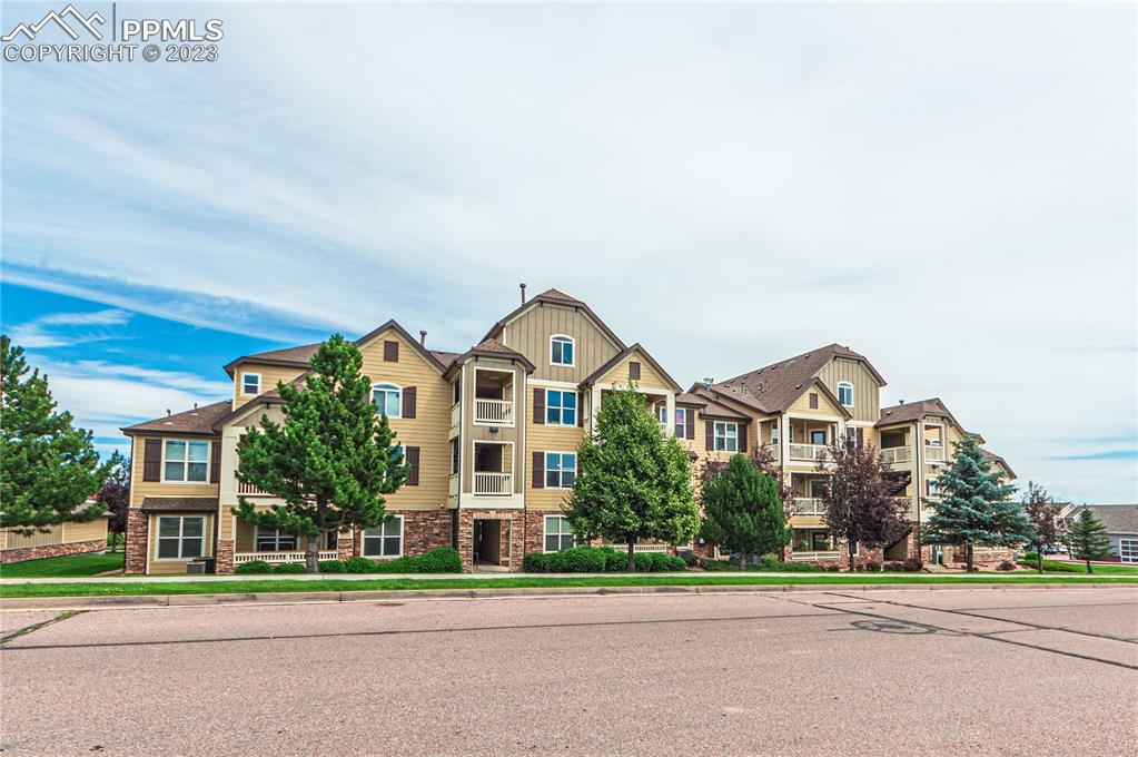 5354 Palomino Ranch Point, Unit 205 Colorado Springs, CO 80922 - Photo 25 of 26 front view of a house with a yard
