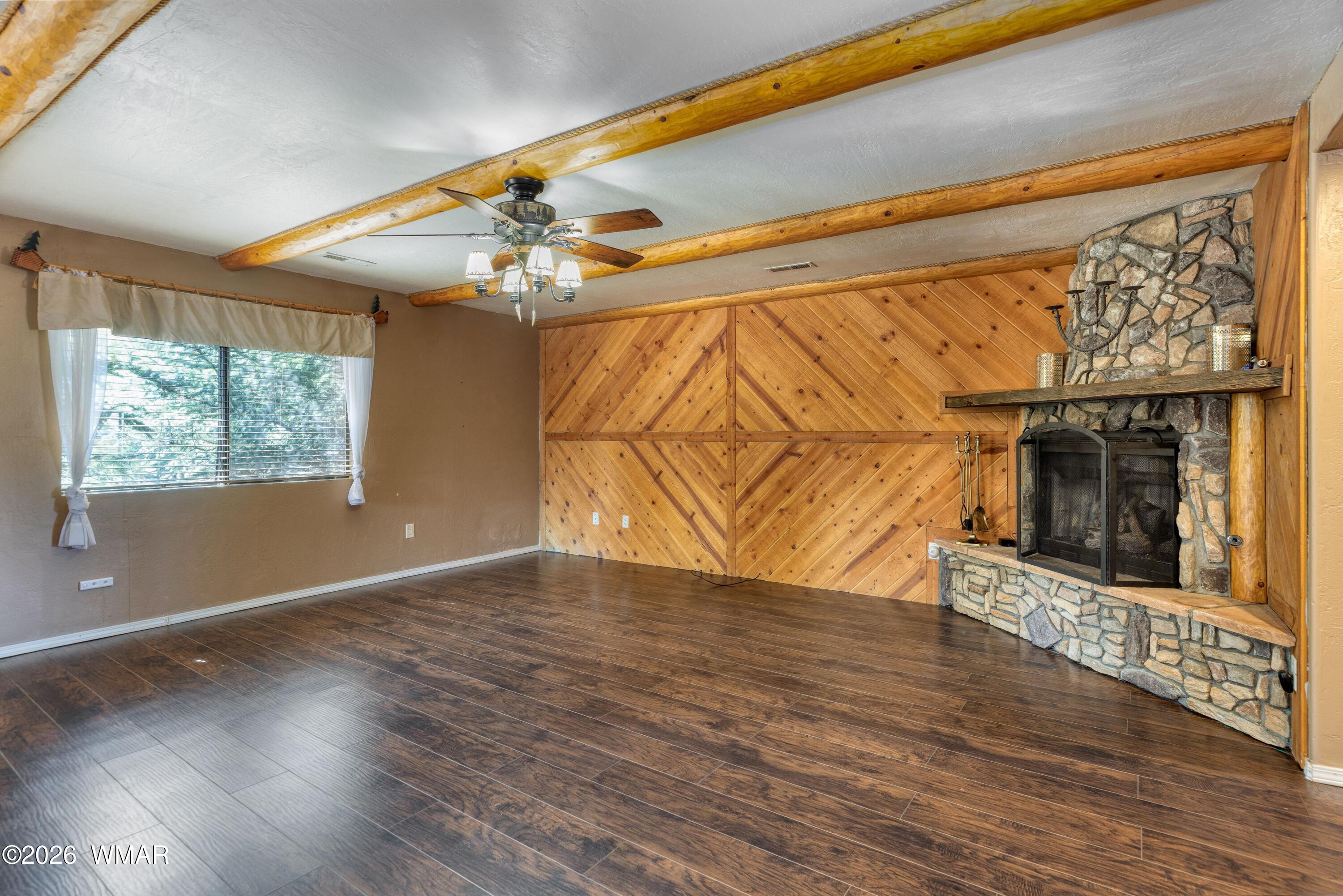 2722 Bain Trail Overgaard, AZ 85933 - Photo 3 of 28 a view of an empty room with wooden floor and a window