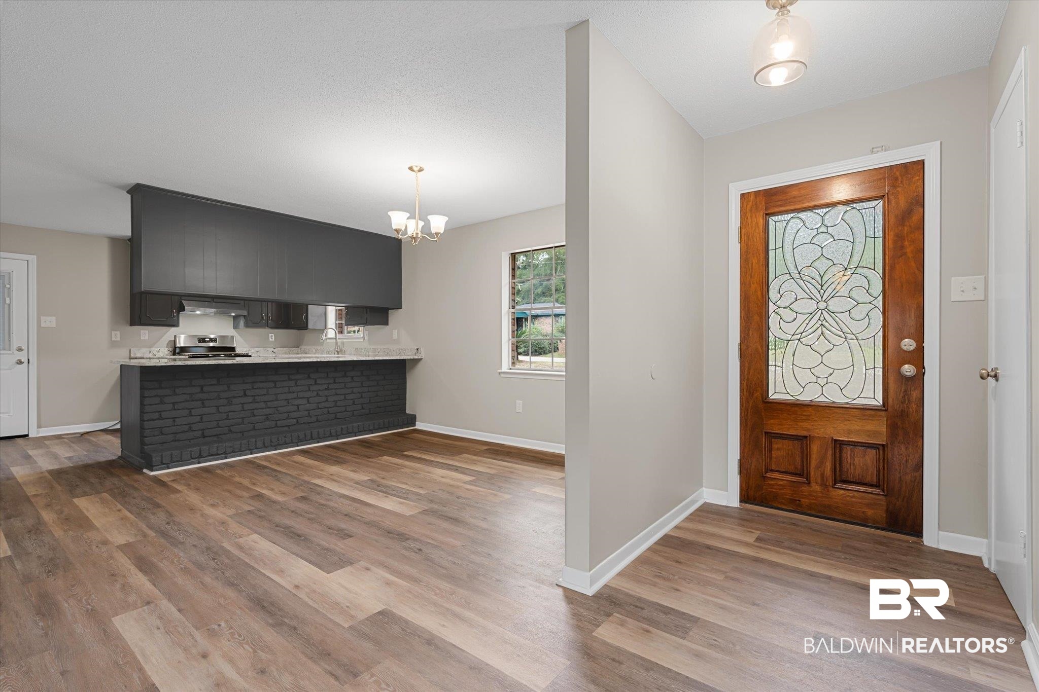 5015 Golfway Drive Eight Mile, AL 36613 - Photo 2 of 31 Entryway with a chandelier, sink, and light hardwood / wood-style floors