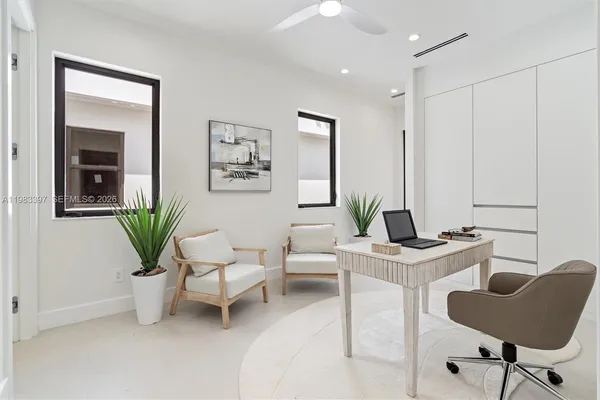 a living room with furniture and potted plant