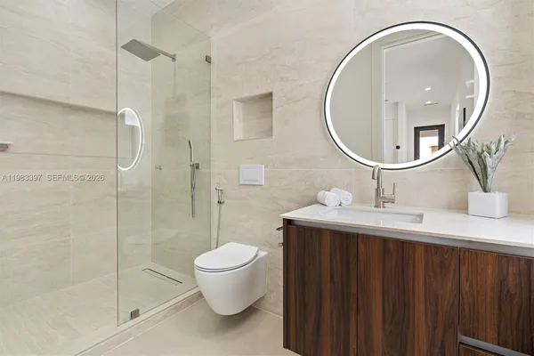 a bathroom with a sink a toilet and a mirror