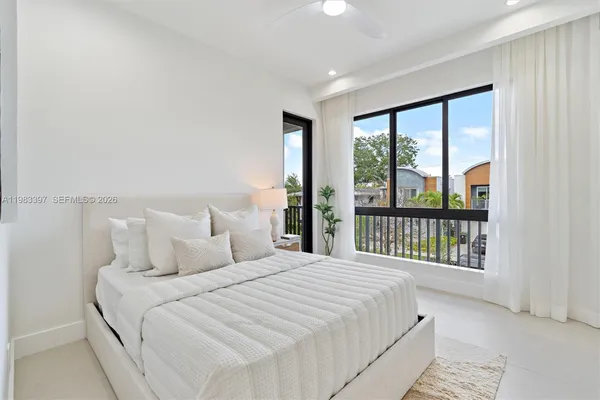a bedroom with a large bed and a large window