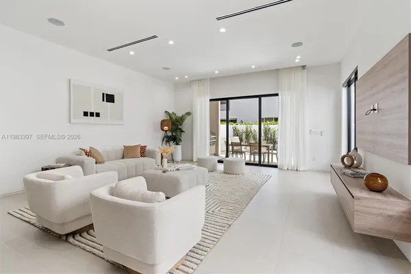 a spacious bedroom with a bed and glass door