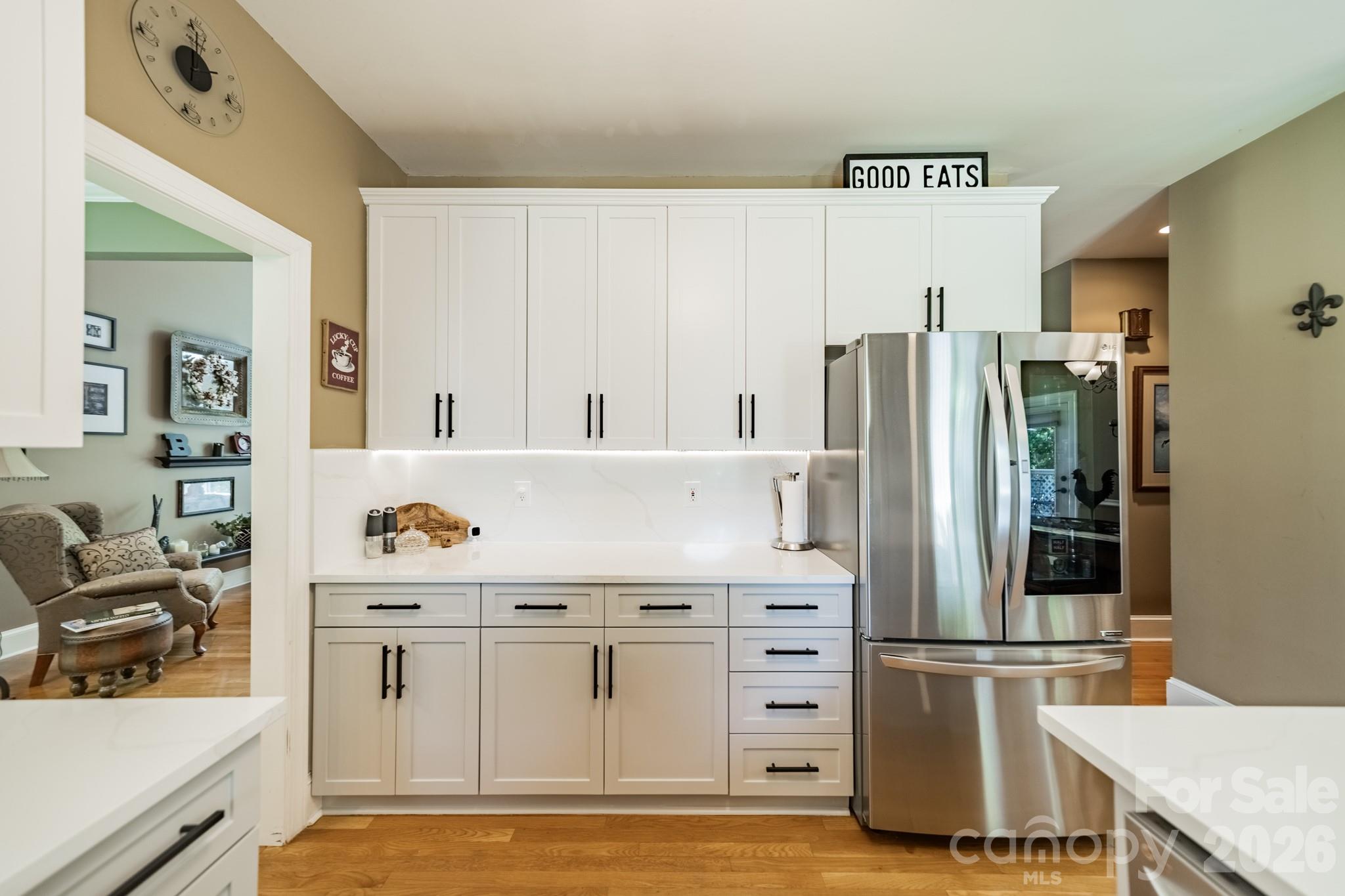 11043 Seven Coves Drive Tega Cay, SC 29708 - Photo 27 of 45 a kitchen with stainless steel appliances a refrigerator and a stove top oven