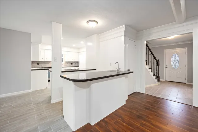 a kitchen with granite countertop a refrigerator and a sink