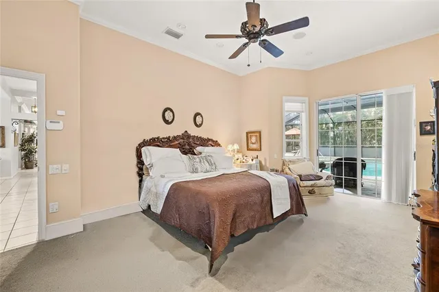 a spacious bedroom with a bed and ceiling fan