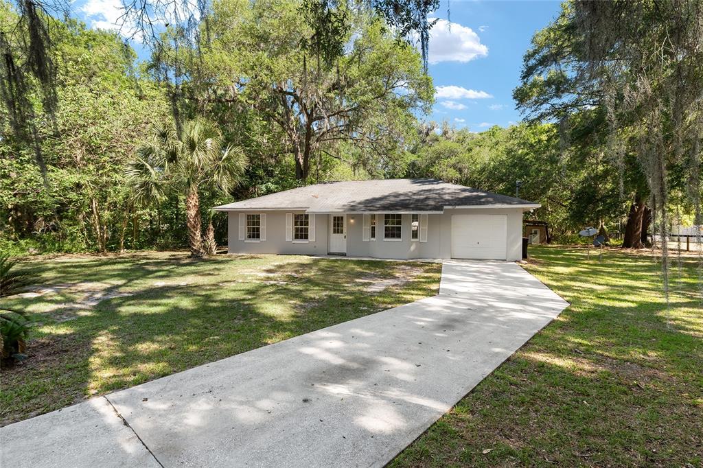 4329 Northwest 155th Street Reddick, FL 32686 - Photo 6 of 52 a front view of a house with a yard