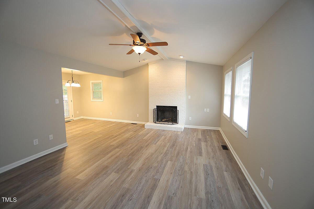 8009 Boxer Place Wake Forest, NC 27587 - Photo 2 of 11 a view of empty room with wooden floor and fan