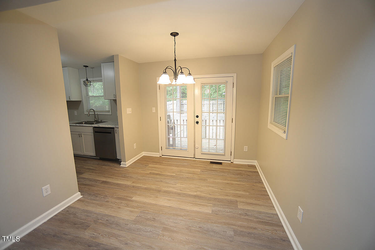 8009 Boxer Place Wake Forest, NC 27587 - Photo 4 of 11 a view of an empty room with kitchen and window
