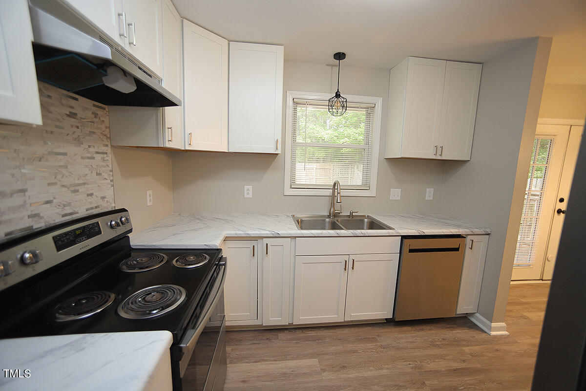8009 Boxer Place Wake Forest, NC 27587 - Photo 6 of 11 a kitchen with a stove and a sink