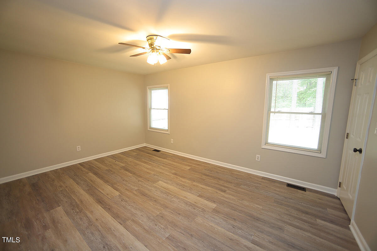 8009 Boxer Place Wake Forest, NC 27587 - Photo 7 of 11 a view of an empty room with wooden floor and a window