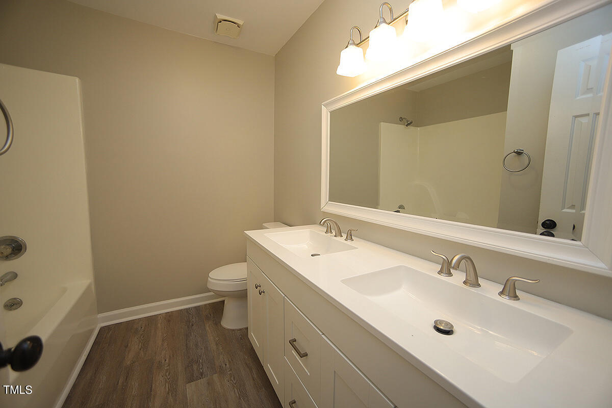 8009 Boxer Place Wake Forest, NC 27587 - Photo 8 of 11 a bathroom with a sink a toilet and shower