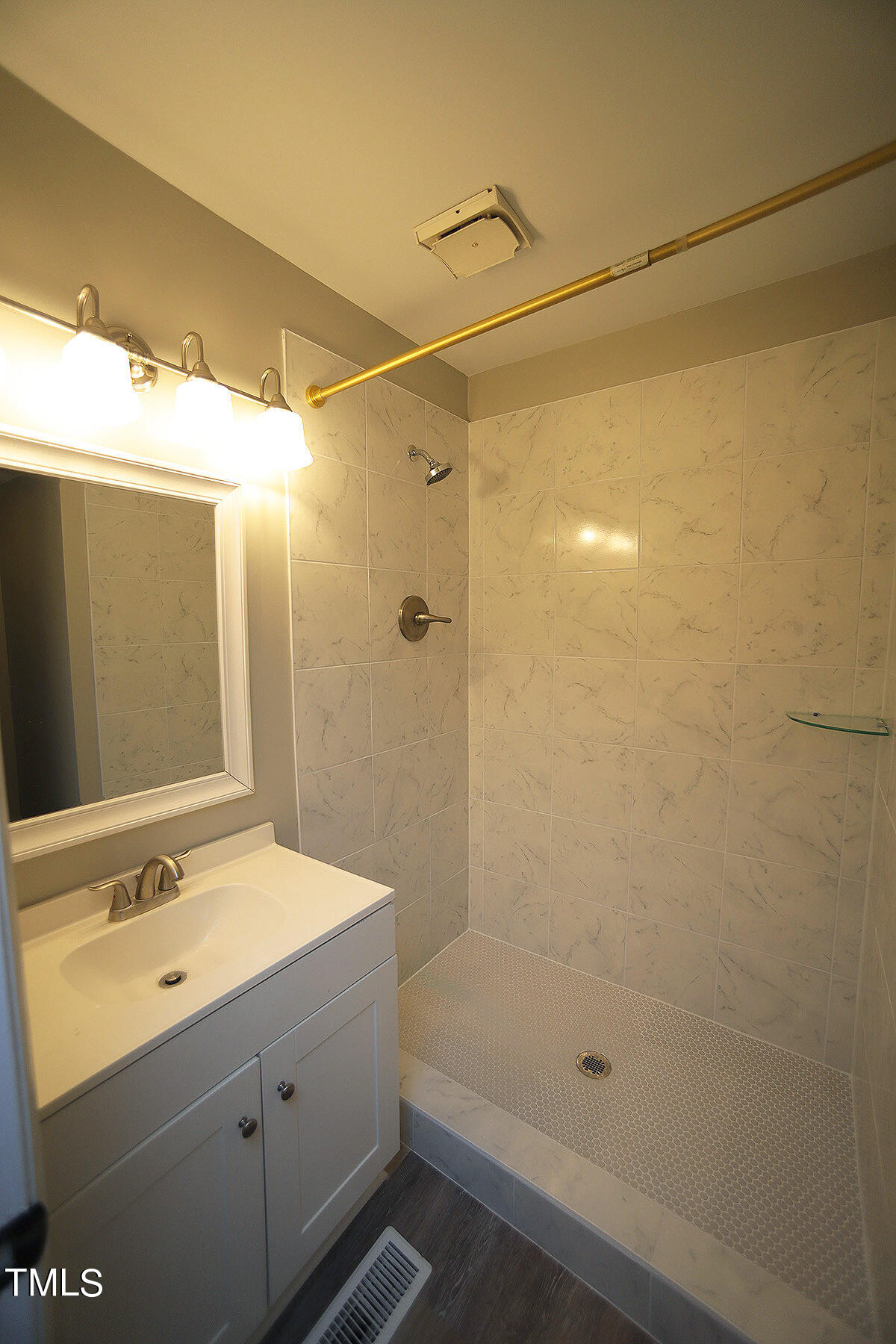 8009 Boxer Place Wake Forest, NC 27587 - Photo 10 of 11 a bathroom with a sink shower and a mirror