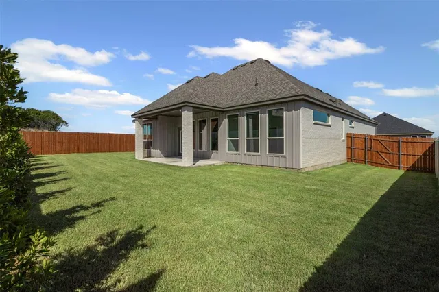 a view of a house with yard and a garden