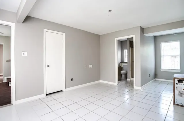 an empty room with closet area