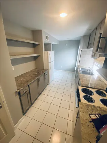 a room with washing machine and cabinets
