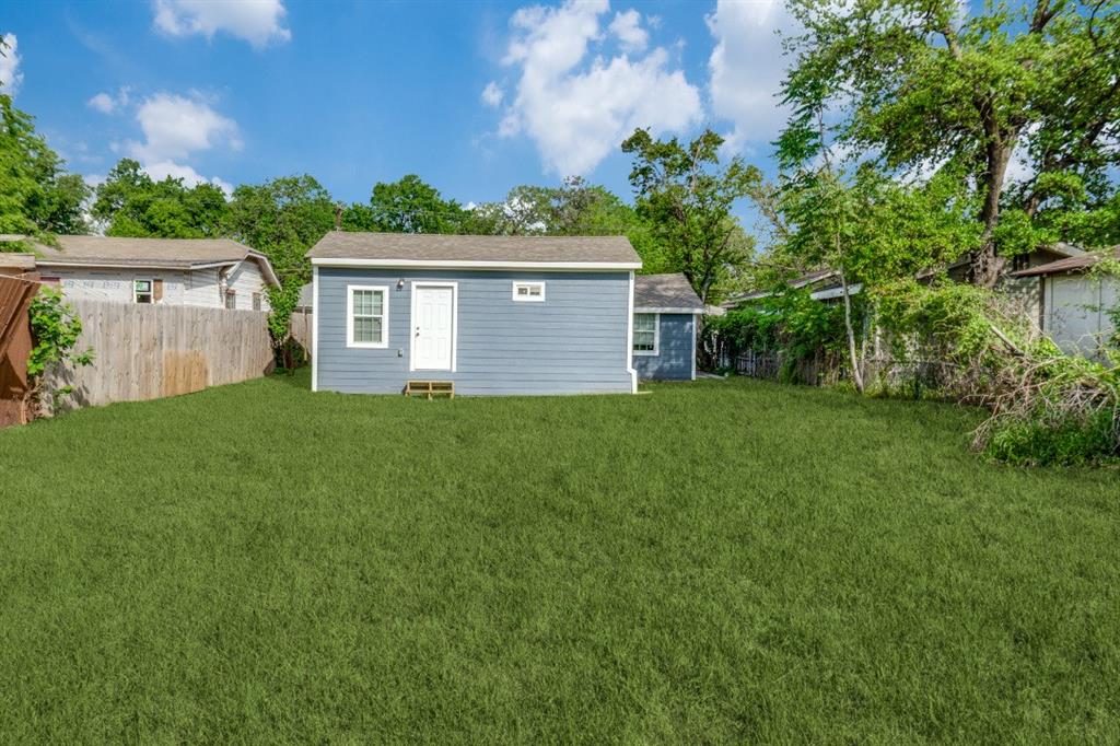 2238 Macon Street Dallas, TX 75215 - Photo 12 of 12 a view of a house with a yard and a large tree