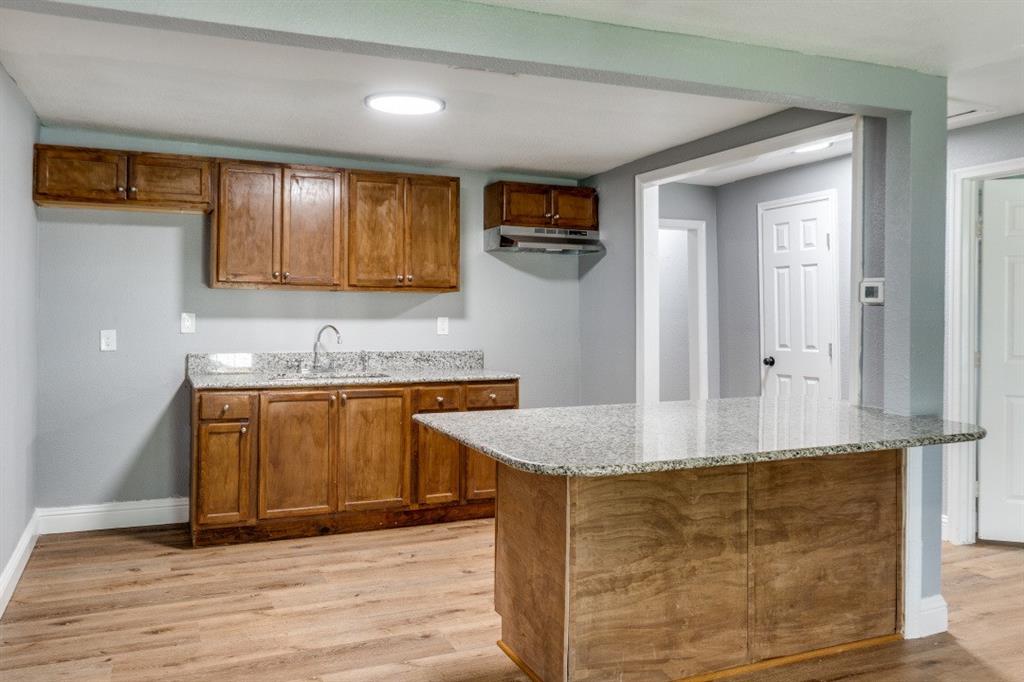 2238 Macon Street Dallas, TX 75215 - Photo 4 of 12 a kitchen with stainless steel appliances granite countertop a sink and a granite counter tops