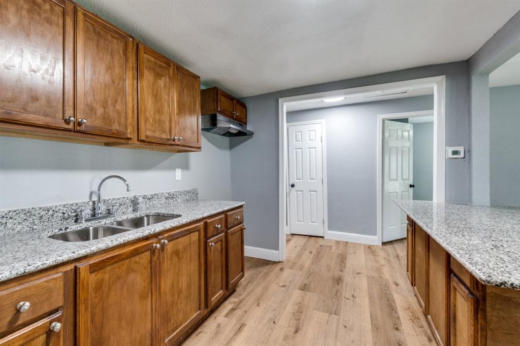 2238 Macon Street Dallas, TX 75215 - Photo 5 of 12 a kitchen with a sink a counter space and wooden floor