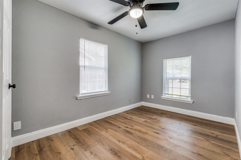 2238 Macon Street Dallas, TX 75215 - Photo 7 of 12 a view of an empty room with wooden floor and a window