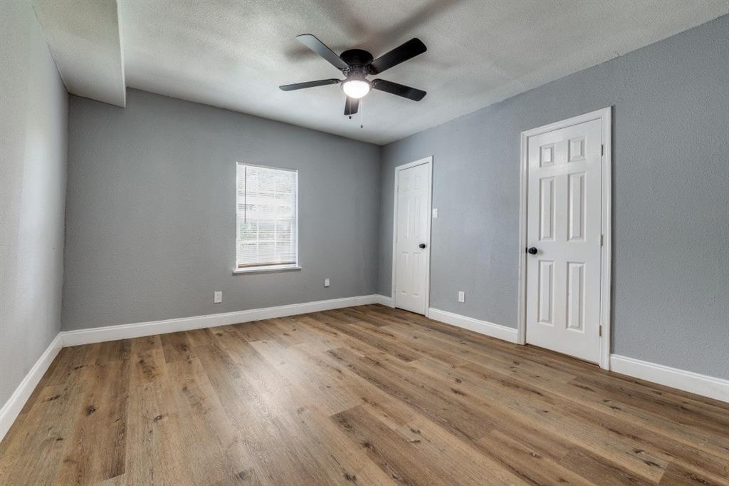 2238 Macon Street Dallas, TX 75215 - Photo 9 of 12 an empty room with wooden floor and windows