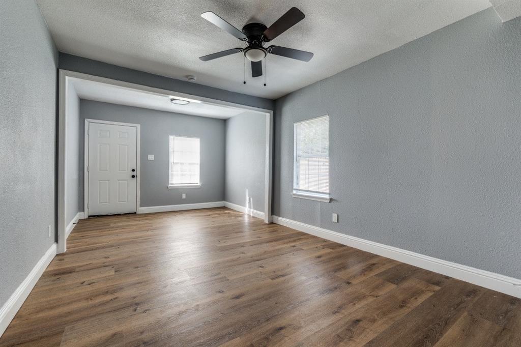 2238 Macon Street Dallas, TX 75215 - Photo 10 of 12 a view of a livingroom with a chandelier fan and windows