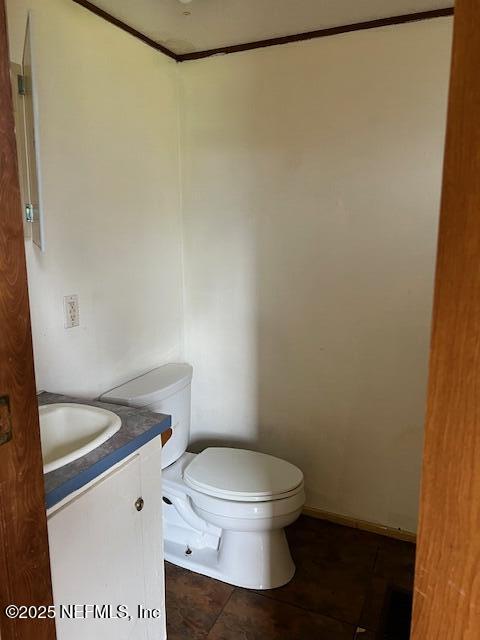 10287 Southwest 113th Street Starke, FL 32091 - Photo 3 of 8 a white toilet sitting next to a white sink and vanity