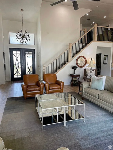 838 East Mountain Road North Ogden, UT 84414 - Photo 3 of 37 Two-story living area featuring a prominent staircase with black wrought iron spindles and light wood newel posts