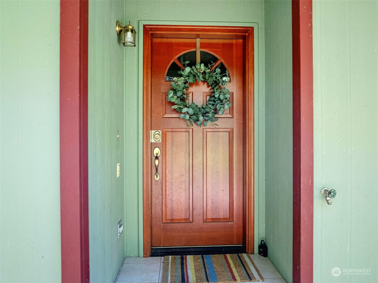 17410 Elhi Rim Road East Bonney Lake, WA 98391 - Photo 2 of 40 a view of a hallway with wooden floor and a rug