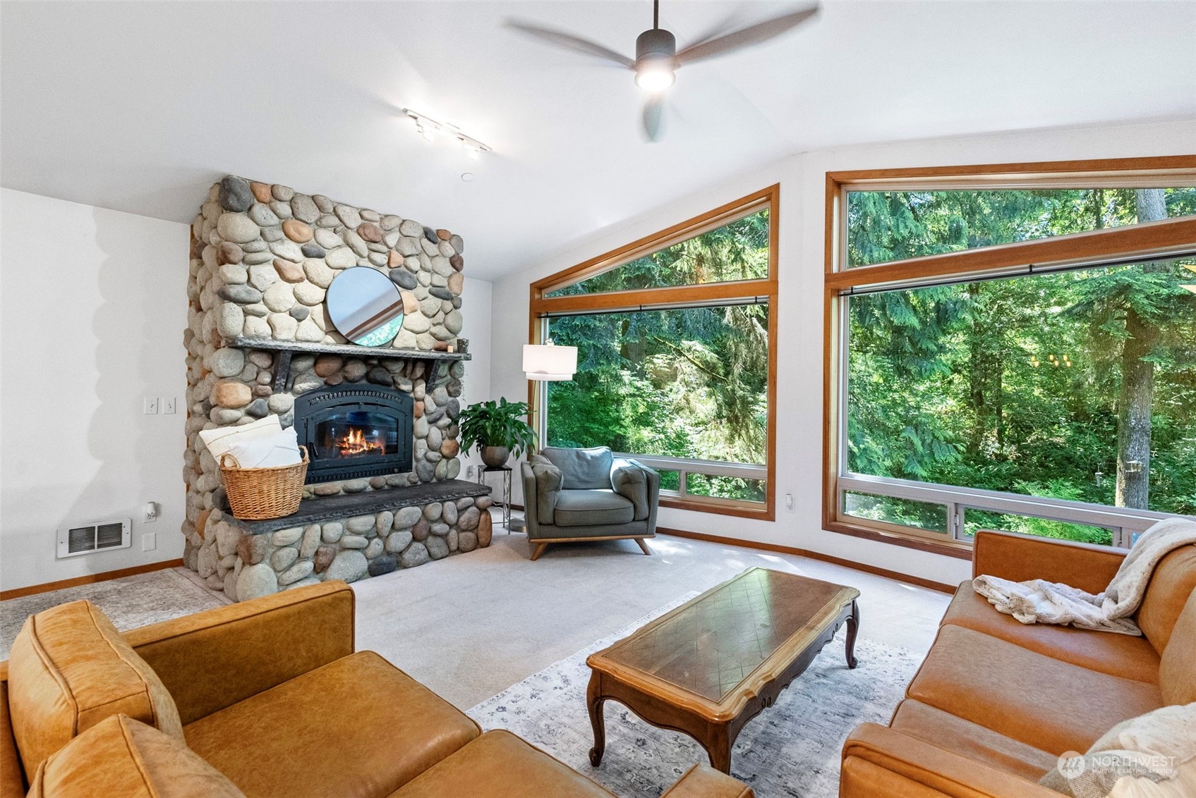 17410 Elhi Rim Road East Bonney Lake, WA 98391 - Photo 3 of 40 a living room with furniture a fireplace and a large window