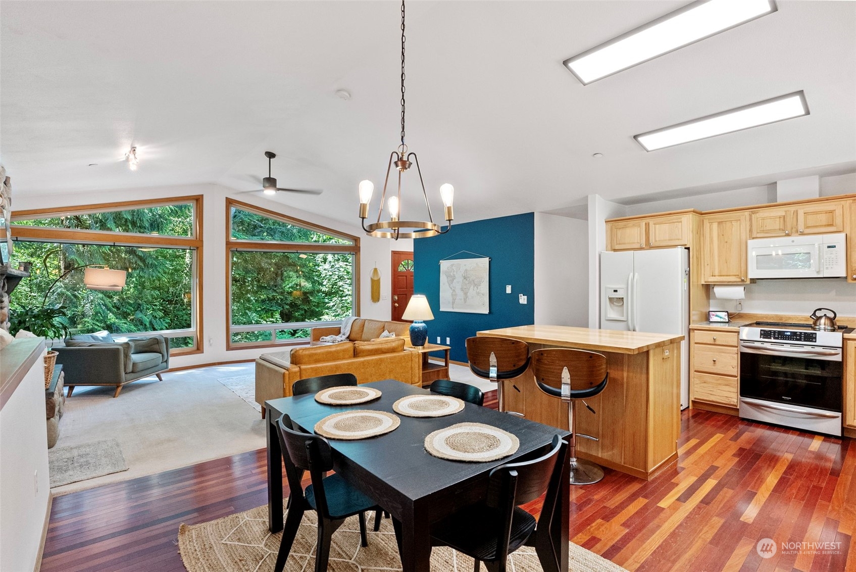 17410 Elhi Rim Road East Bonney Lake, WA 98391 - Photo 8 of 40 a dining room with wooden floor a chandelier a wooden table and chairs