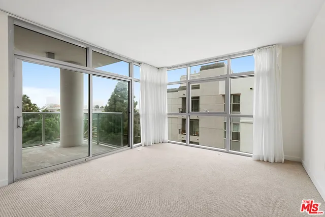 a view of empty room with floor to ceiling window and floor