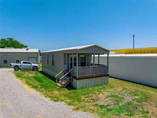 a view of a backyard with sitting area