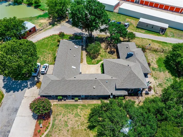 a aerial view of a house with garden and a car park