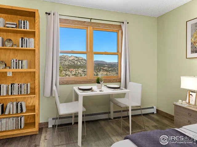 a bedroom with bed and wall painting with wooden floor